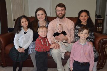 A family sitting on a couch together.